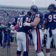Mike Singletary (50) gets a bear hug from teammate Steve McMichael prior to the game against the Pittsburgh Steelers in Chicago, Dec. 13, 1992.